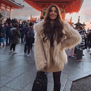 Long sleeved faux fur coat. Champagne colored